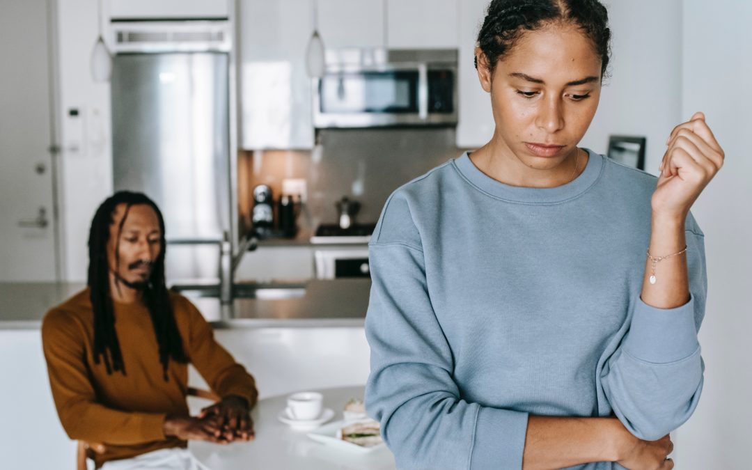 couple looking defeated in house kitchen